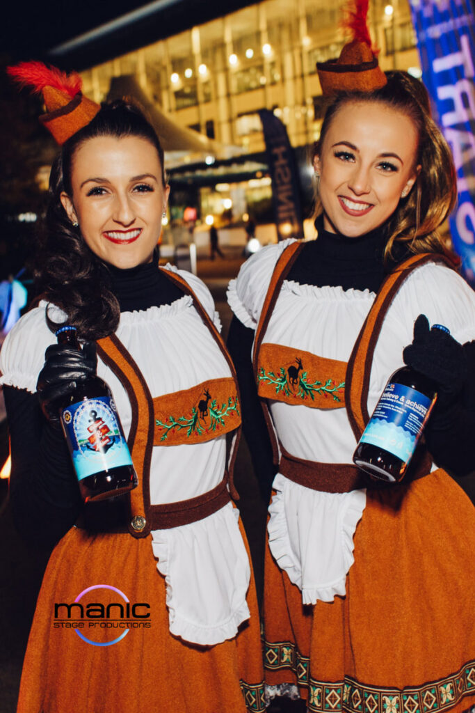 Bavarian beer wenches holding beer and mixing and mingling with party goers wearing wench costumes