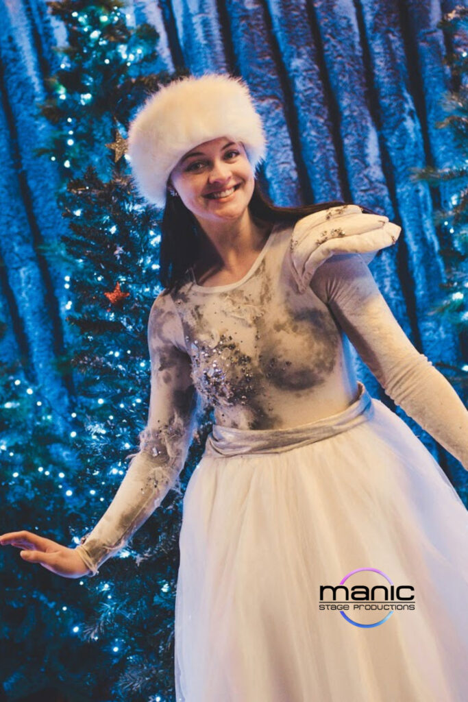 Christmas glitter fairy spinning next to a christmas tree wearing fur and glitter looking all warm and christmassy